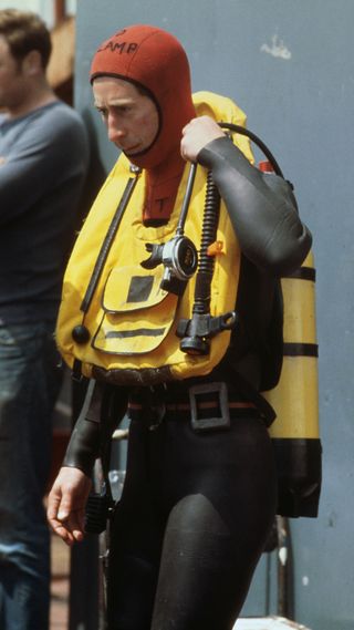 King Charles wearing a wetsuit and goggles in preparation for a dive to view the Mary Rose shipwreck