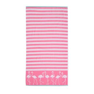 A pink and white striped beach towel with a flamingo pattern