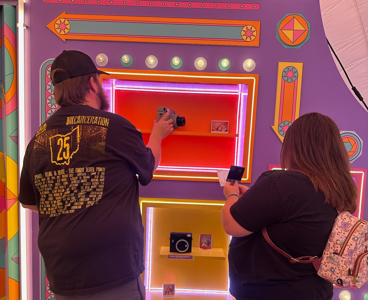 Guests try out Instax cameras at an event