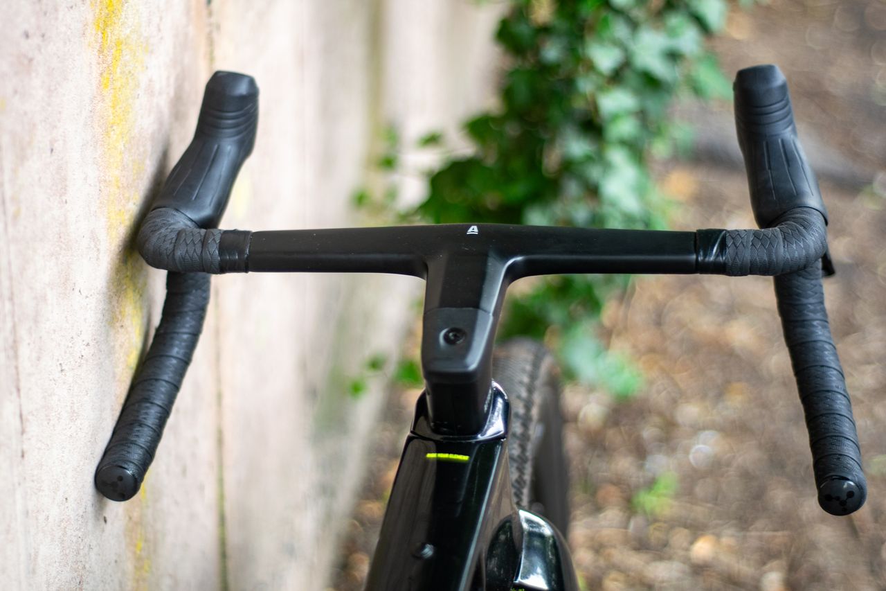 An Argon 18 Anti Matter gravel bike leaning against a concrete wall.