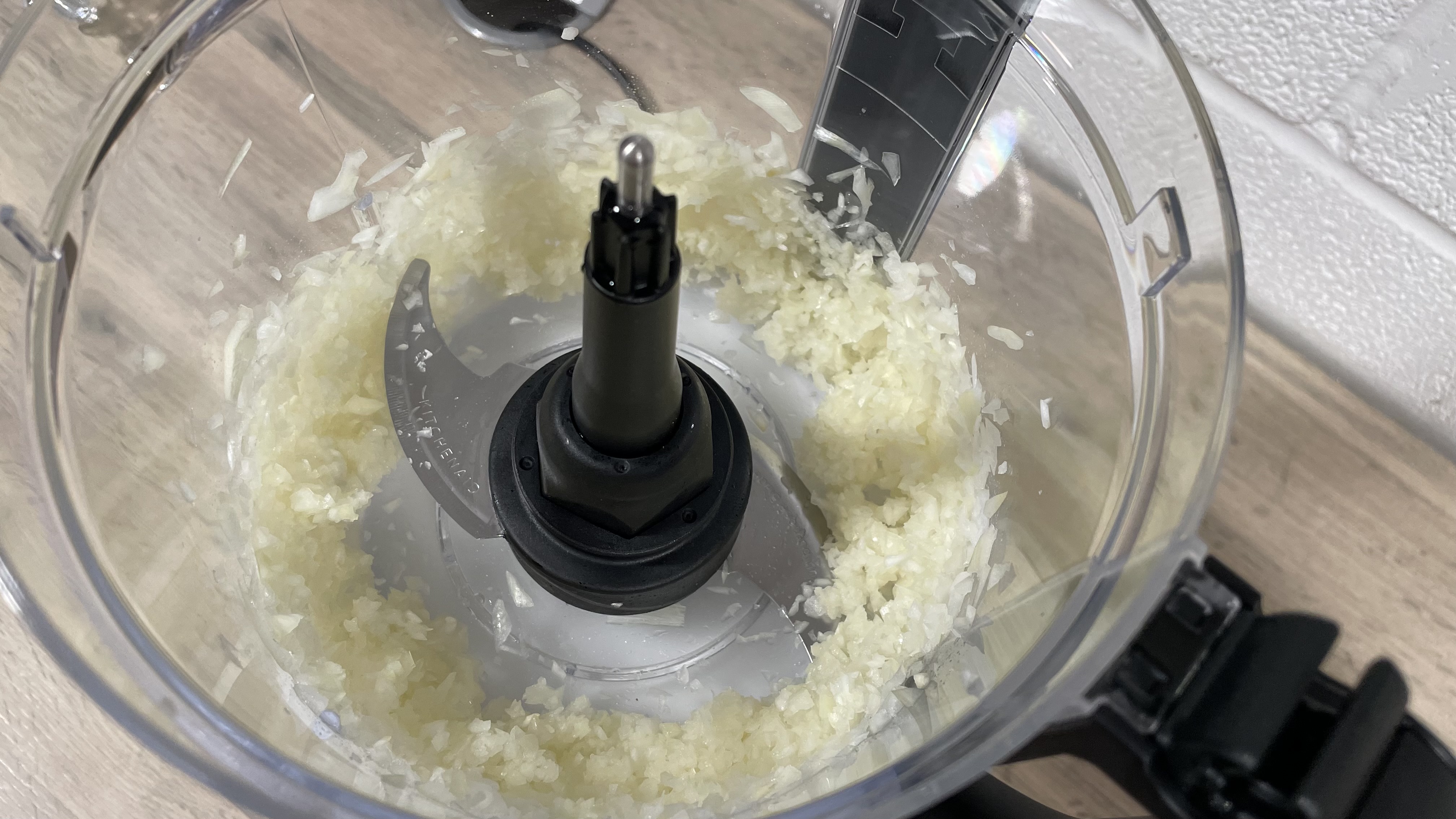 A close up photo of some onion that was chopped by the Kitchen Aid 13 cup processor.