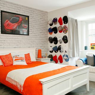bedroom with brick wall and hats on wall