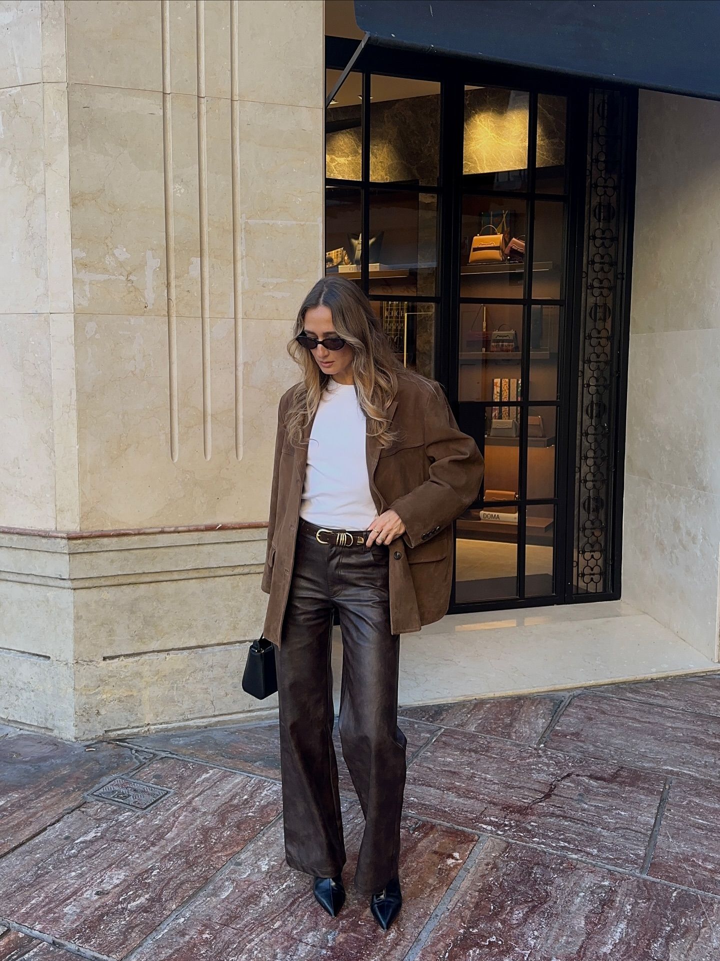 A woman wearing a fall leather-pant outfit in 2026.