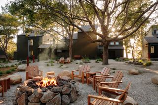 outdoor seating around firepit, with lodges in the background