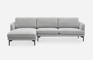 A modern grey chaise sofa with black metal legs