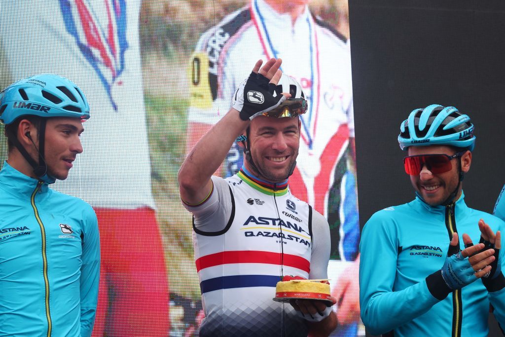 Astana Qazaqstan Teams British rider Mark Cavendish C holding a cake to celebrate his 38th birthday waves during the presenation of the teams prior to the fifteenth stage of the Giro dItalia 2023 cycling race 195 km between Seregno and Bergamo on May 21 2023 Photo by Luca Bettini AFP Photo by LUCA BETTINIAFP via Getty Images