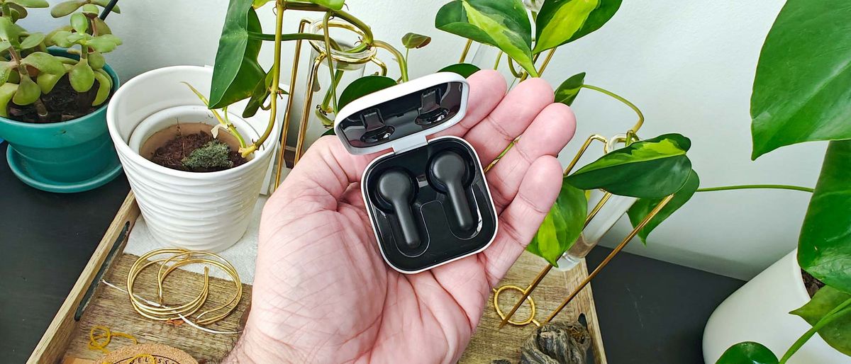 Reviewer holding Amazon Echo Buds in charging case