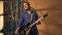 Carl Carlton posing with his guitar