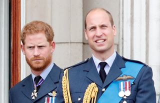 Prince Harry, Duke of Sussex and Prince William, Duke of Cambridge watch a flypast to mark the centenary of the Royal Air Force from the balcony of Buckingham Palace on July 10, 2018 in London, England
