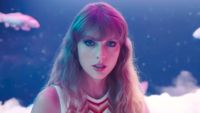 Taylor Swift wearing moody makeup with koi fish behind her in Lavender Haze music video.