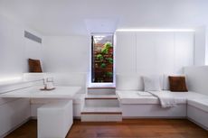 All white micro apartment with view to garden