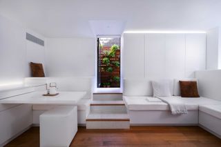 All white micro apartment with view to garden