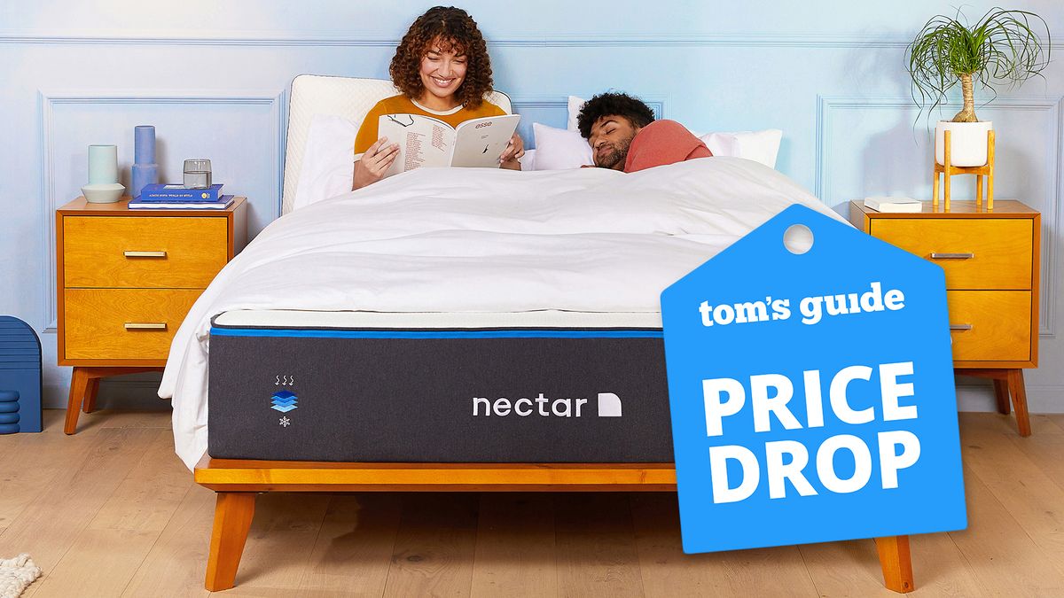 Two people lie on a Nectar Memory Foam mattress in a bedroom, a Tom&#039;s Guide price drop deals graphic is in the corner (right)