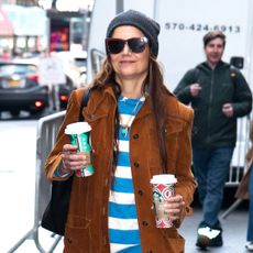 Katie Holmes wearing a suede jacket and striped shirt