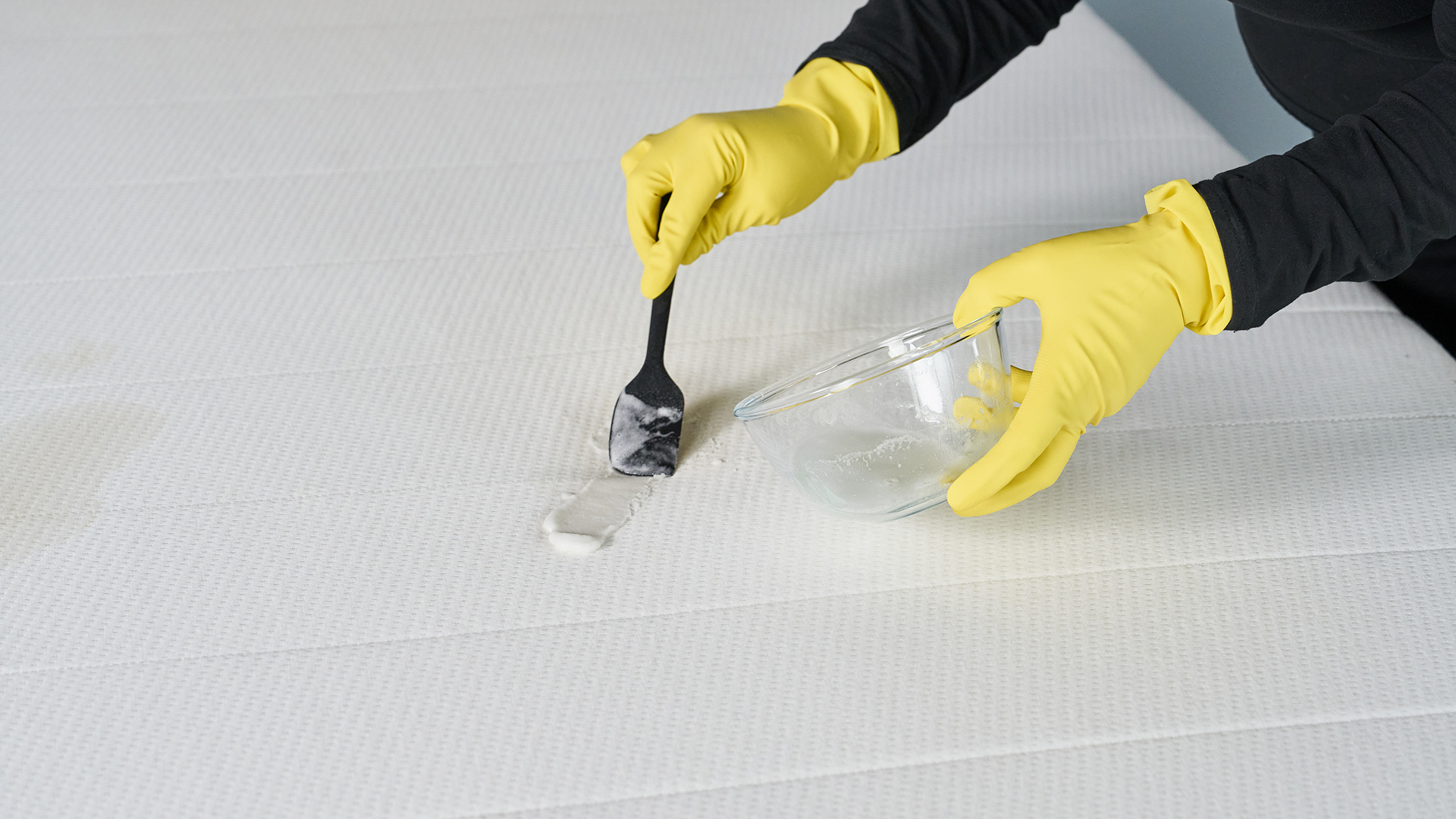 Tom&#039;s Guide Sleep Team mixing baking soda in a bowl and applying it to a stain