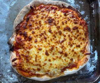 A cheese pizza made in the Cuisinart Indoor Pizza Oven