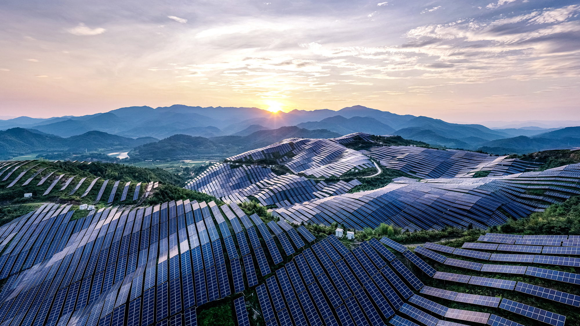 Drone point of view at the solar power station on the top of the mountain at sunset