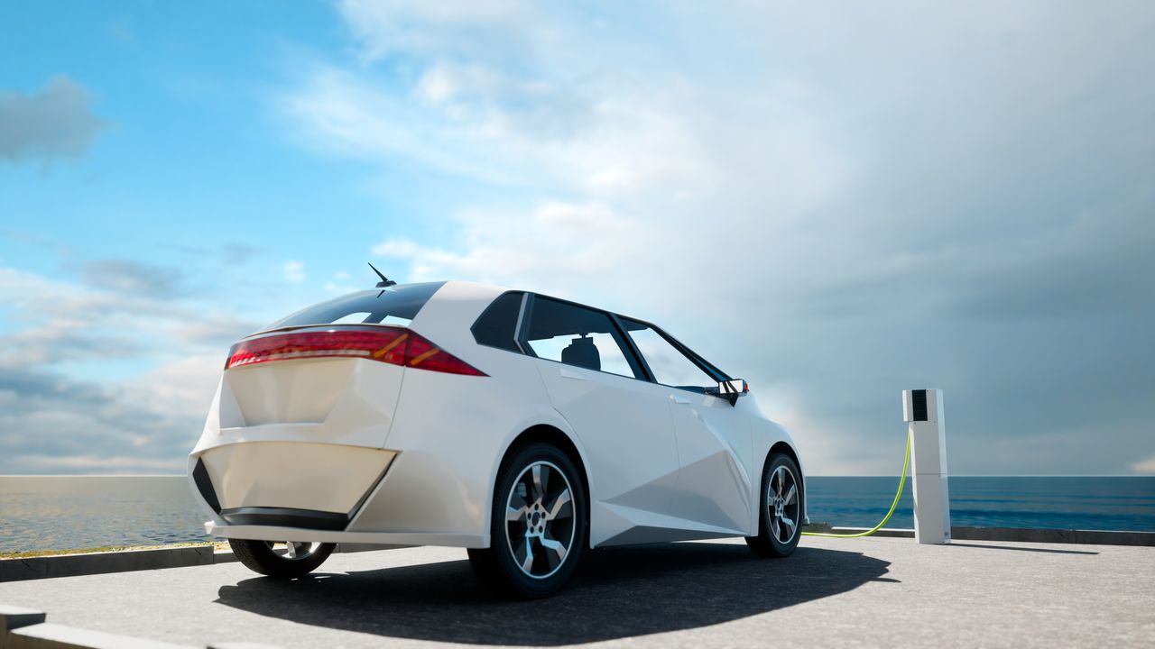 image of an electric vehicle next to a charger