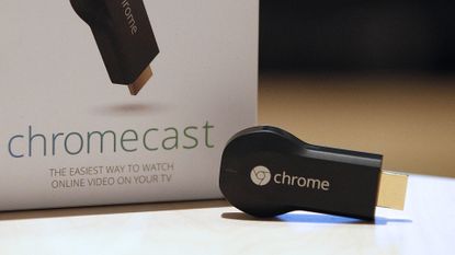 Google Chromecast first-gen on a table with its box