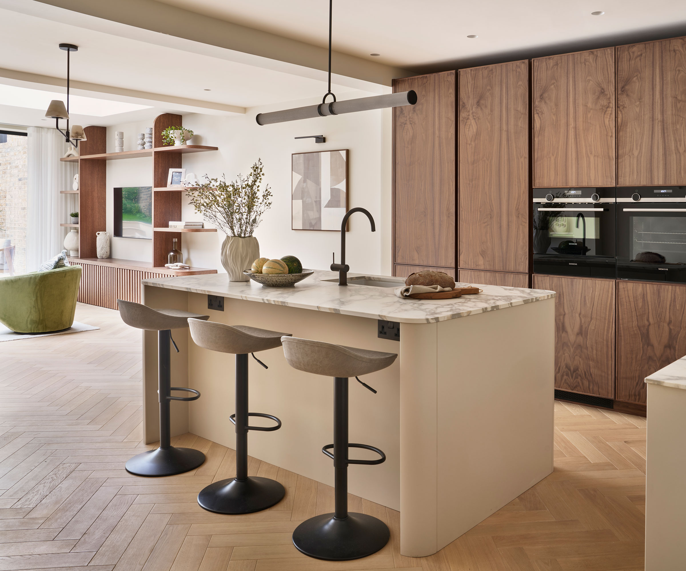 white and walnut kitchen with herringbone flooring and marble topped kitchen island