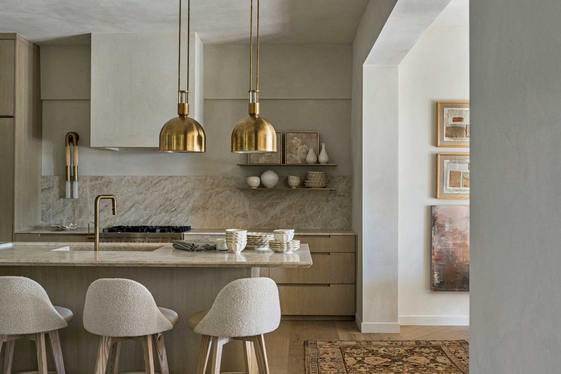 a marble backsplash in a neutral kitchen