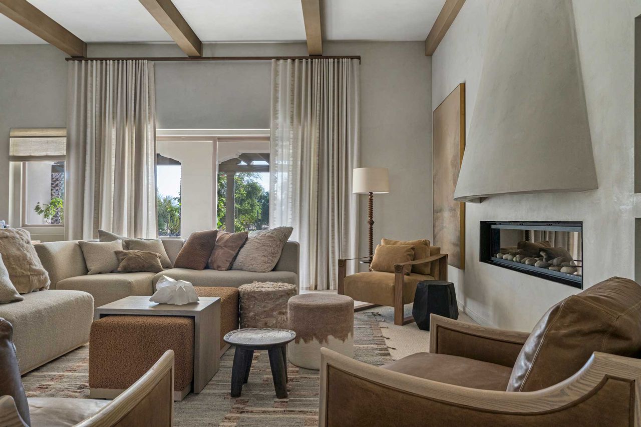 a living room with carpet and a rug on top