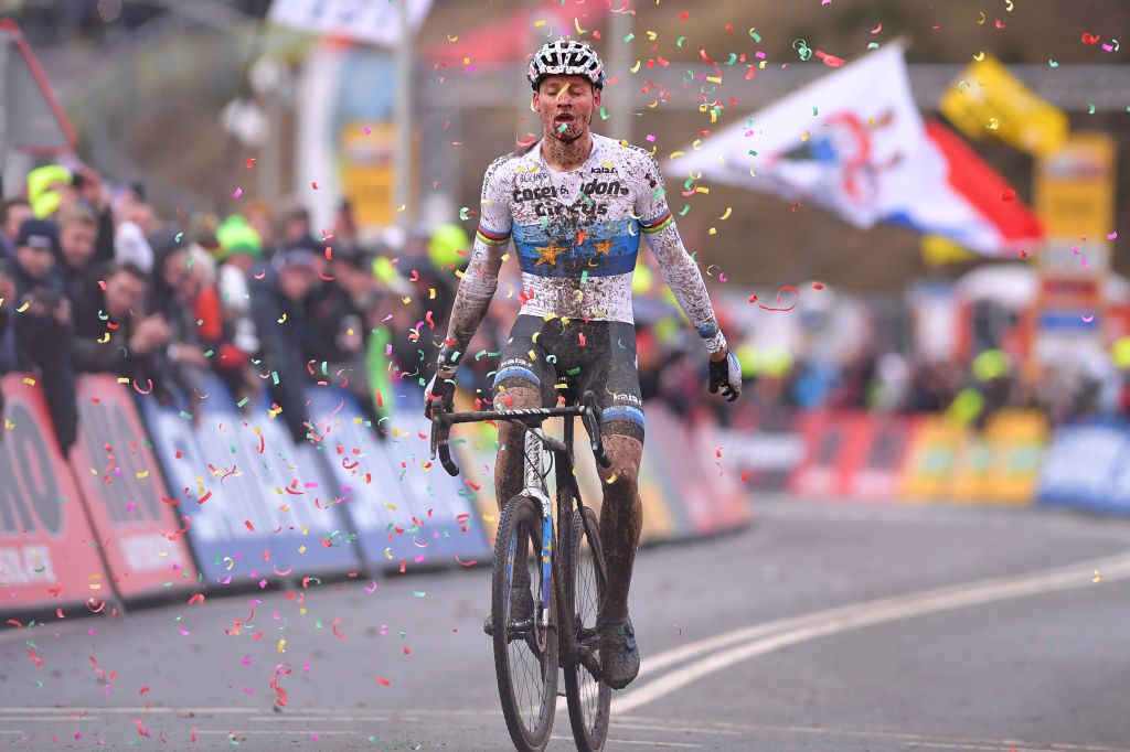 Confetti falls on Mathieu van der Poel as he crosses the finish line