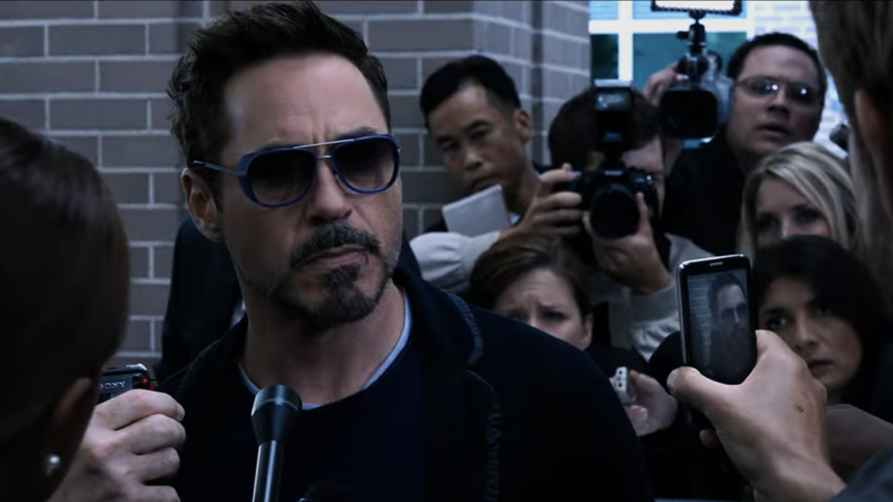 Robert Downey Jr. as Tony Stock talking to press in Iron Man 3