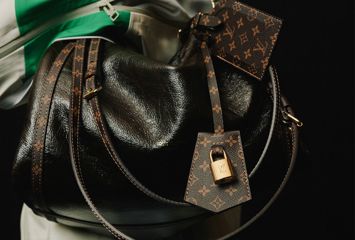 Model on the runway carrying the Louis Vuitton Express bag.