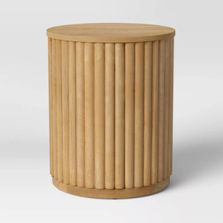 A fluted wooden stool