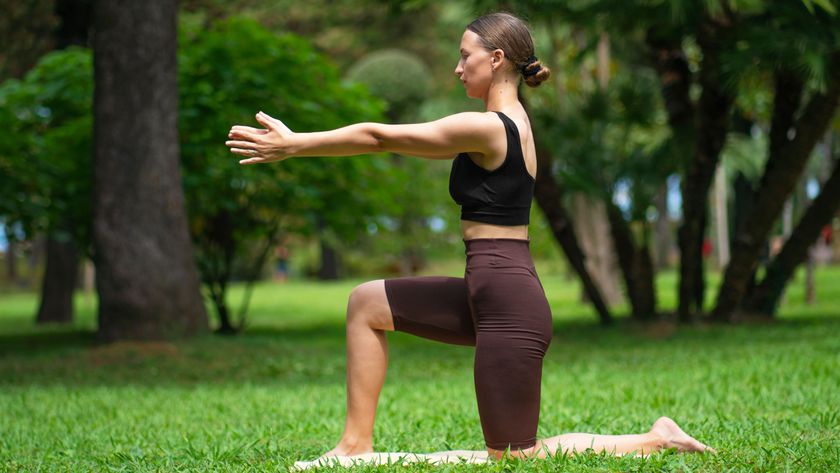 a photo of a woman outside doing a hip flexor stretch