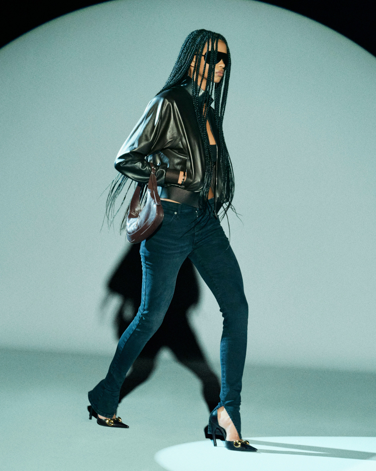 A model in the pre-fall 2026 Gucci lookbook wearing a leather jacket and skinny jeans with heels.