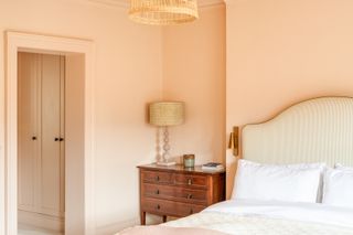 A warm colored bedroom painted in Setting Plaster