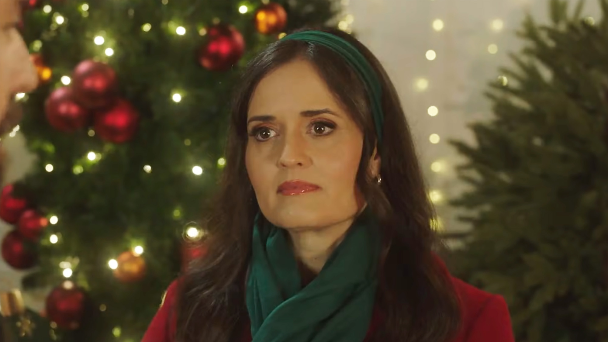 Danica McKellar looking dewy (and hot literally) in a scarf and coat while filming a Christmas movie.