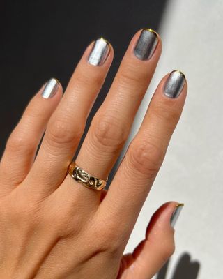 @betina_goldstein silver manicure with gold French tips