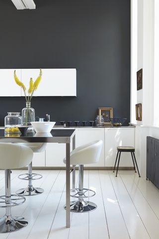 Dark grey dining room with white cabinets by Little Greene