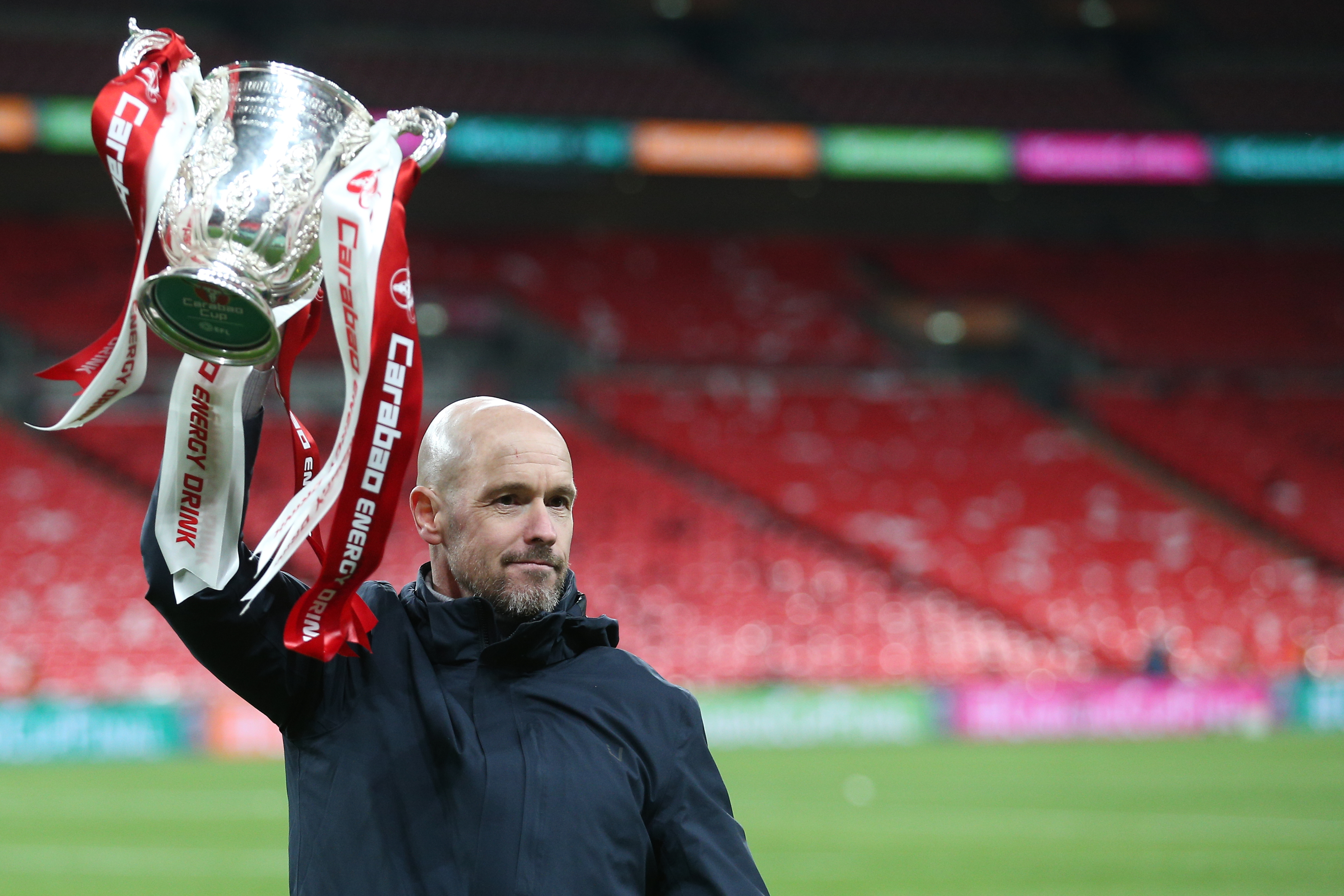 Erik ten Hag celebrates with the League Cup trophy after Manchester United's win over Newcastle United in the 2023 final.