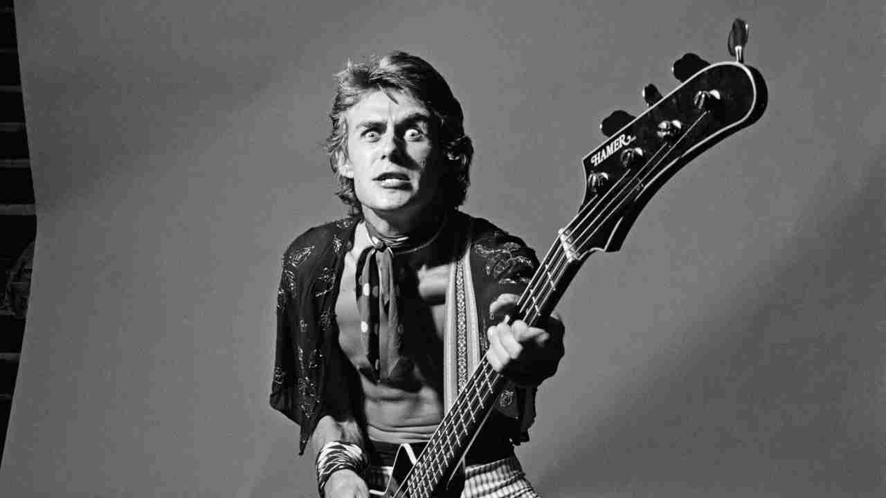 Wishbone Ash&amp;rsquo;s Martin Turner posing for a photograph with a bass guitar in the 1970s