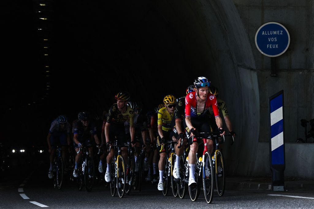 Jumbo-Visma's Dutch rider Dylan Van Baarle cycles ahead of Jumbo-Visma's Danish rider Jonas Vingegaard wearing the overall leader's yellow jersey through a tunnel, in the ascent of the Col de la Ramaz during the 14th stage of the 110th edition of the Tour de France cycling race, 152 km between Annemasse and Morzine Les Portes du Soleil, in the French Alps, on July 15, 2023. (Photo by Anne-Christine POUJOULAT / AFP)