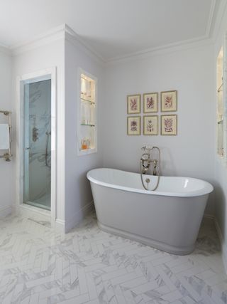 bathroom with gray walls shower enclosure gray freestanding bath artwork and towel rail