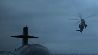 A submarine with a helicopter flying over it in The Hunt For Red October