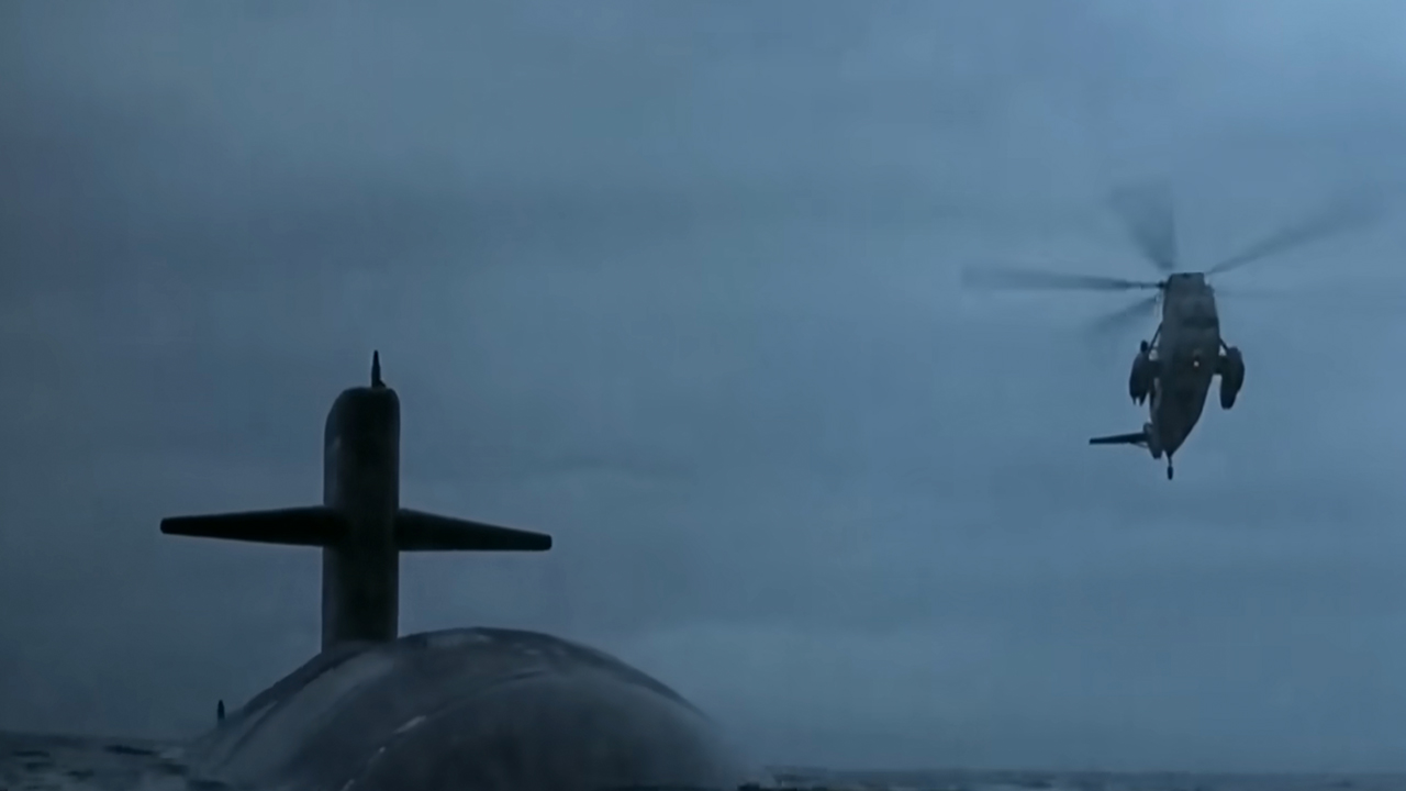 A submarine with a helicopter flying over it in The Hunt For Red October