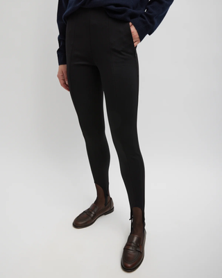 A picture of a woman wearing black leggings.