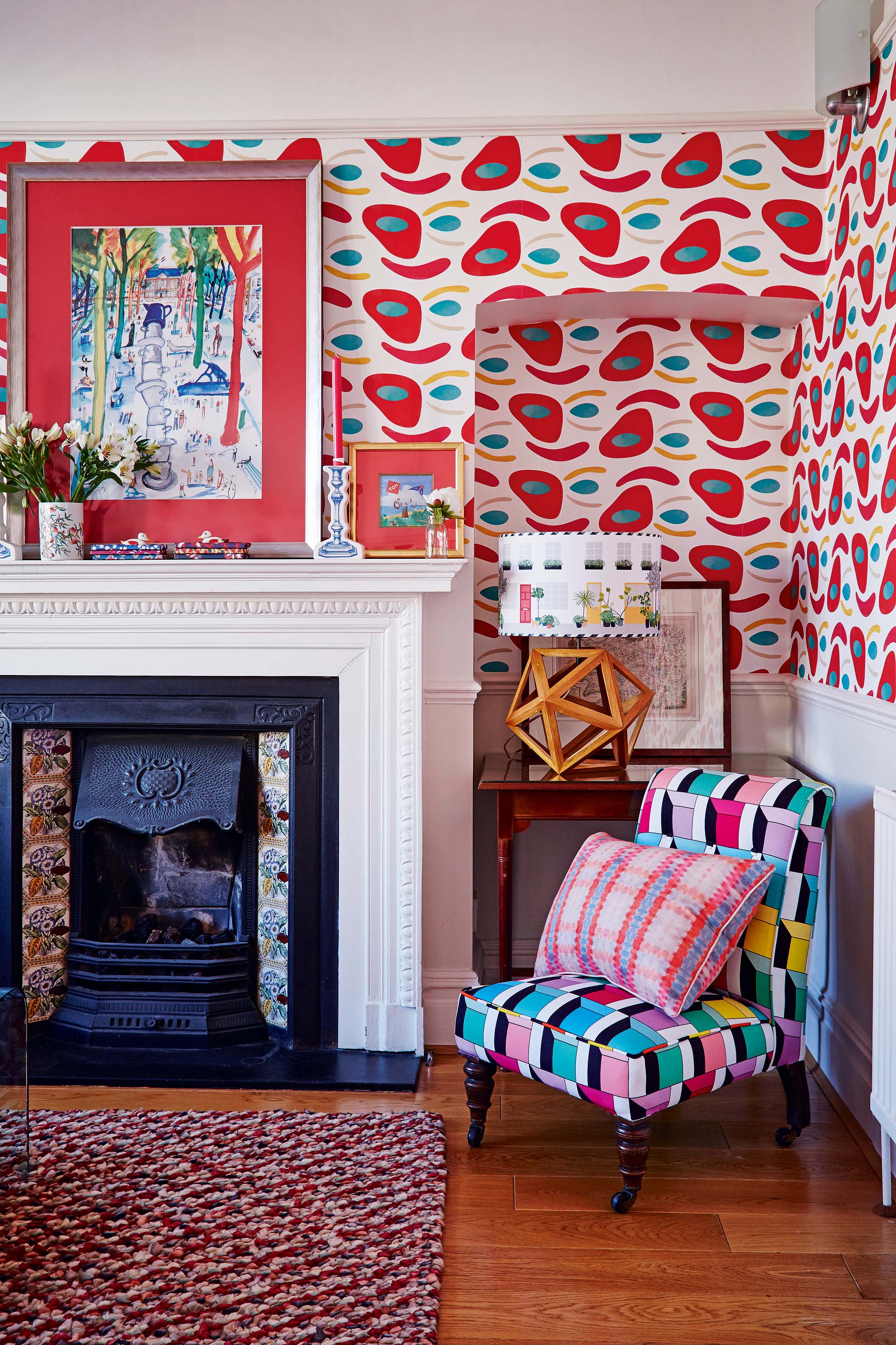 Living room with fireplace, armchair and patterned wallpaper