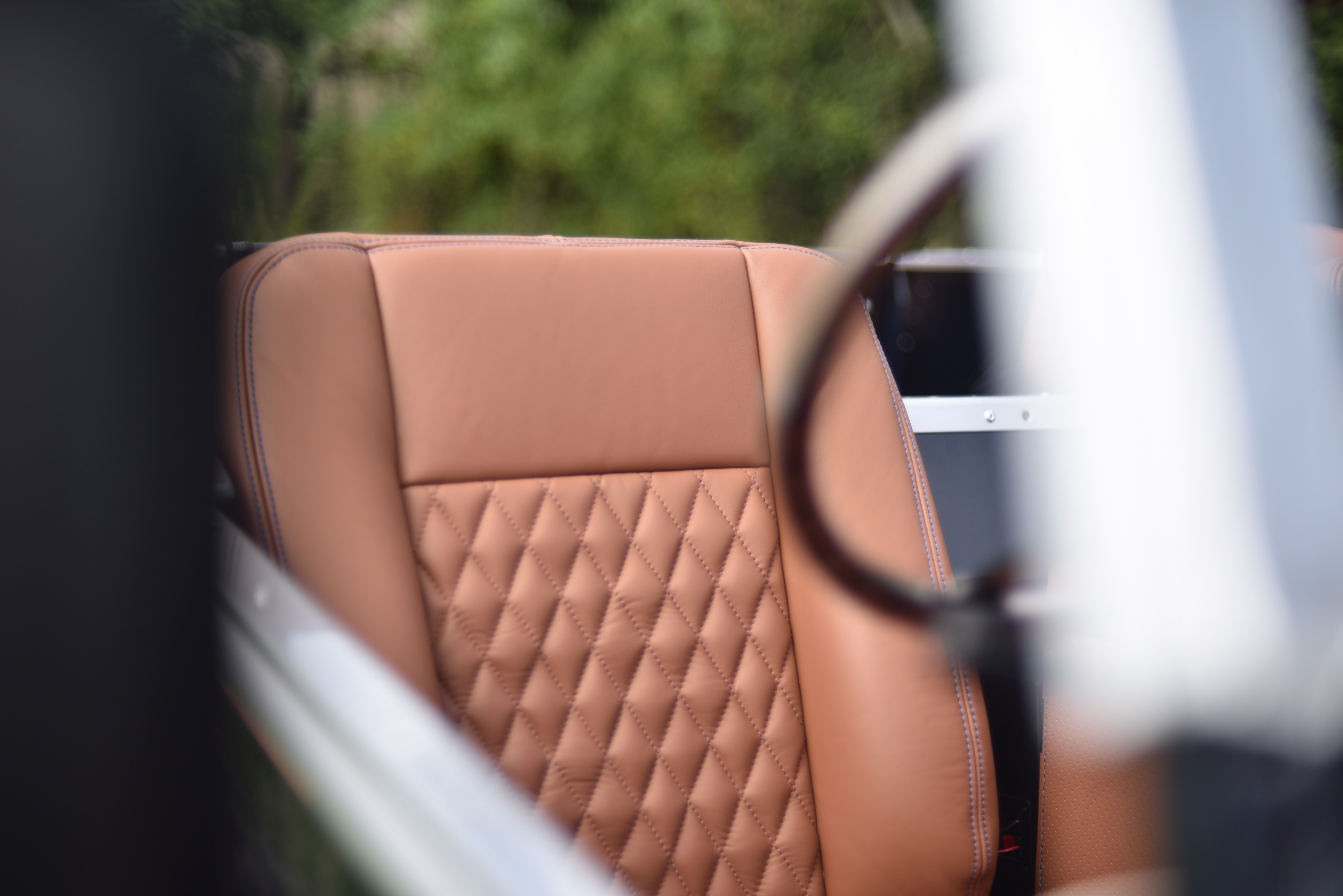 The seats are upholstered in quilted hand-stitched leather