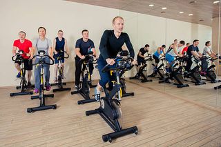 A group of cyclists in a spin class