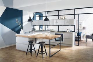 grey handleless kitchen with black frame and wooden flooring in an industrial style