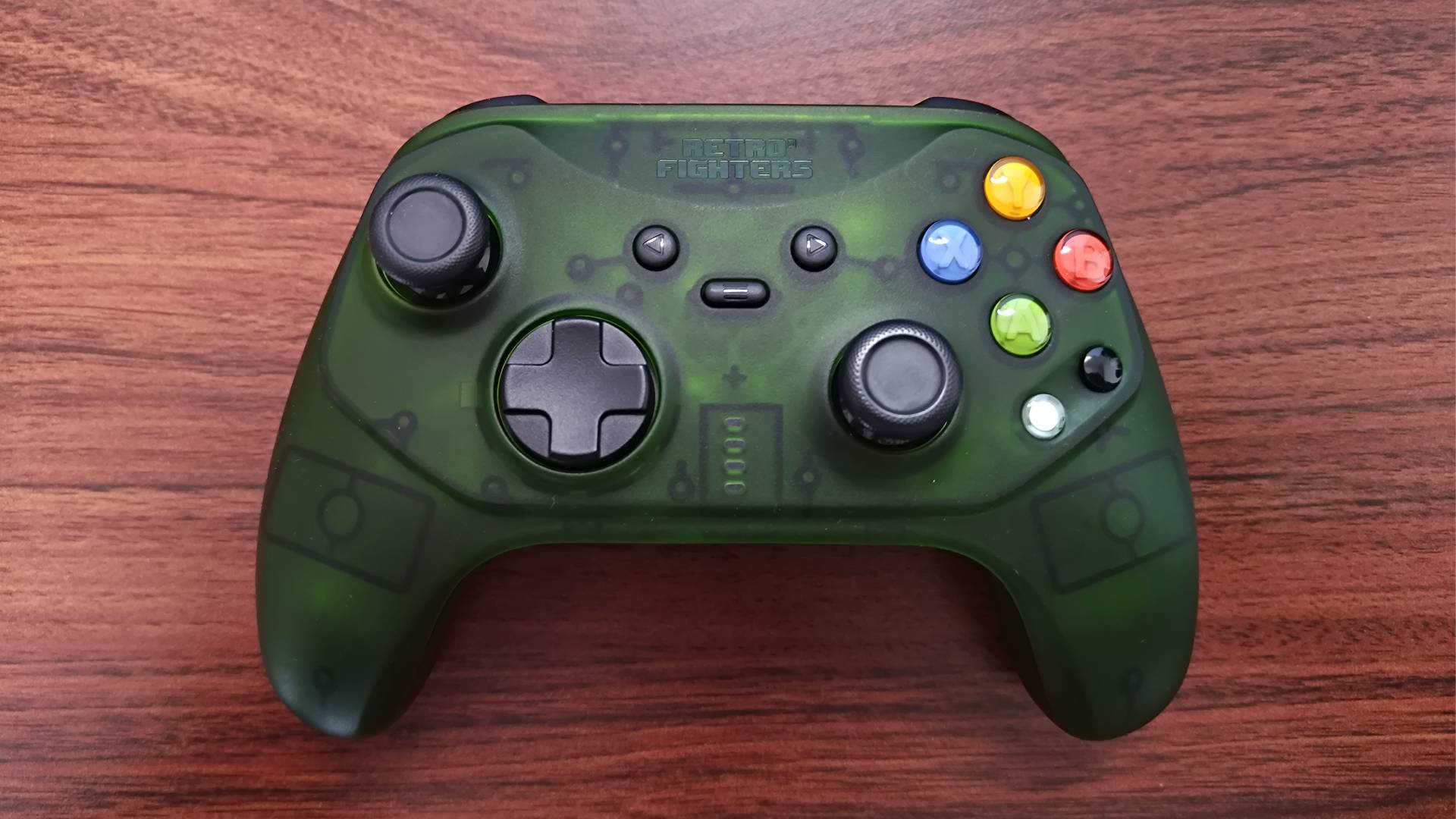 Face view of Retro Fighters Hunter controller for OG Xbox on woodgrain desk.
