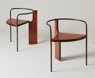 Two wooden chairs with black metal frames