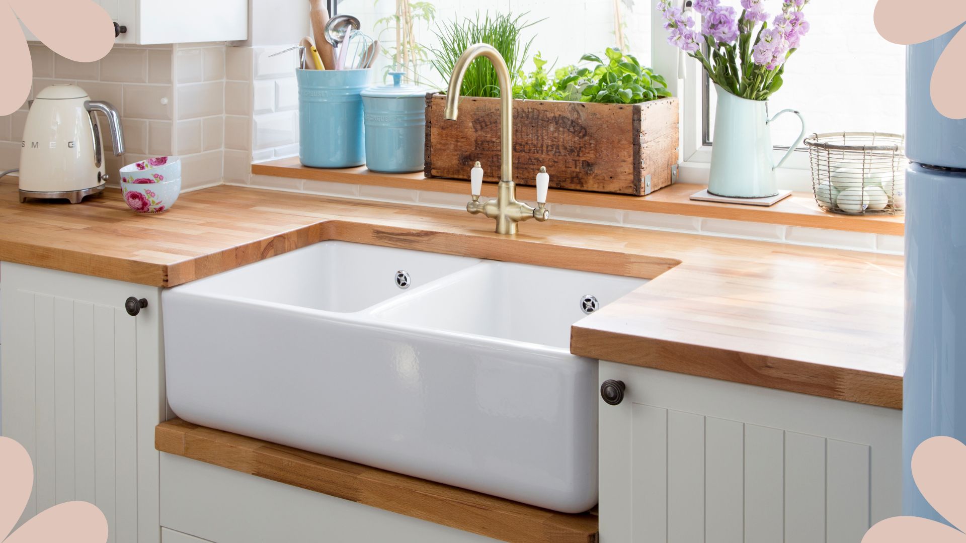 picture of enamel kitchen sink with flowers and herbs next to it